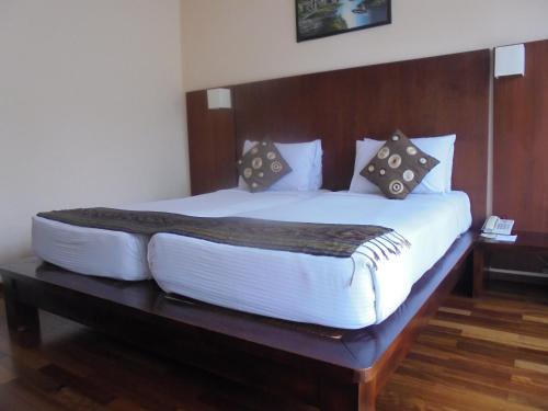 a large bed in a hotel room at Biyukukung Suite & Spa in Ubud