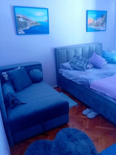 a living room with two beds and a couch at Guest House Cinderella in Herceg-Novi