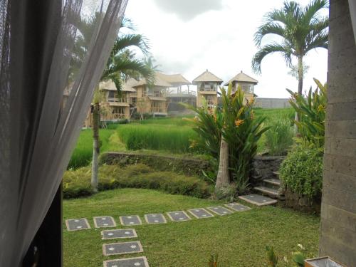 a view from a window of a yard with houses at Biyukukung Suite & Spa in Ubud