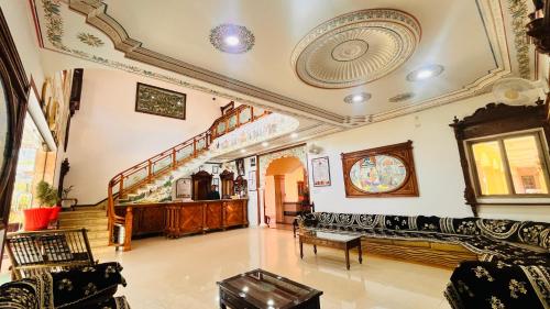 a living room with a couch and a staircase at Hotel Master Paradise, Pushkar, Rajasthan , INDIA in Pushkar