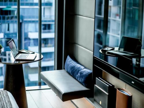 a room with a table with two laptop computers on it at InterContinental Singapore Robertson Quay by IHG in Singapore