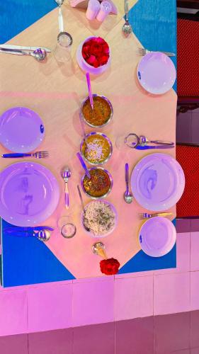 a table with plates and bowls of food on it at Hotel Master Paradise, Pushkar, Rajasthan , INDIA in Pushkar