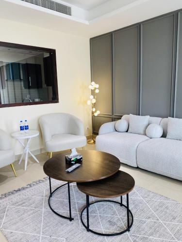 a living room with a couch and a coffee table at One Constitution Avenue by SUPERHOST STAYS in Islamabad