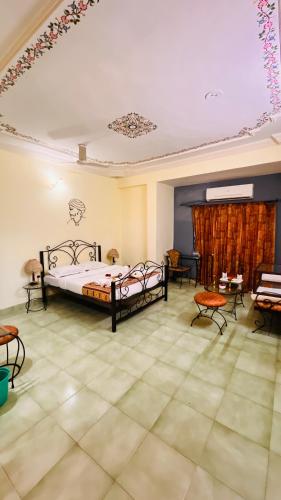 a bedroom with two beds and chairs in a room at Hotel Master Paradise, Pushkar, Rajasthan , INDIA in Pushkar