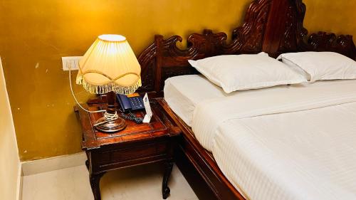 a bedroom with two beds and a lamp on a night stand at Hotel Master Paradise, Pushkar, Rajasthan , INDIA in Pushkar
