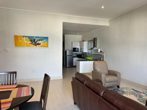a living room with a couch and a table at Townhouse T1, Relax Waterfront in Bijilo