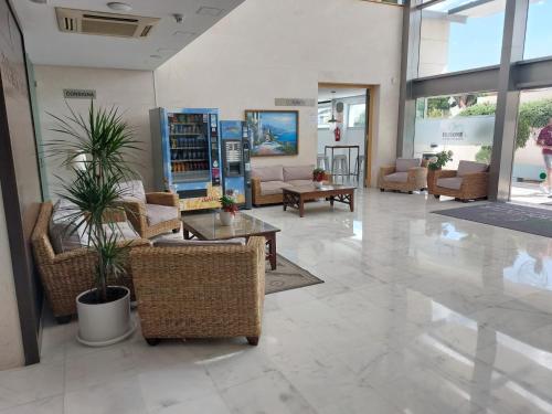 a lobby with couches and tables in a building at Domocenter Apartamentos Turísticos in Bormujos