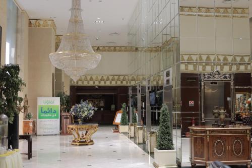 a lobby with a chandelier in a building at Habitat All Suites, Al Khobar in Al Khobar