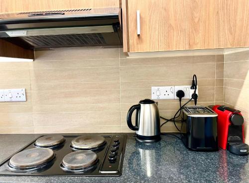 a kitchen counter with a stove top with a coffee maker at Flat in Nicosia City Center - Prevezis Platform 357 in Nicosia