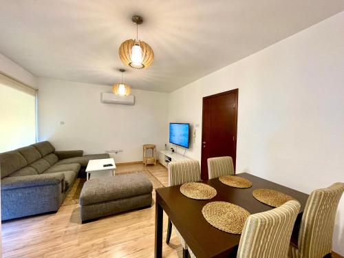 a living room with a table and a couch at Flat in Nicosia City Center - Prevezis Platform 357 in Nicosia