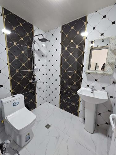 a bathroom with a toilet and a sink at Dreamscape Villa in Gabala