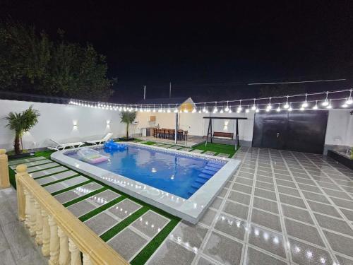 a swimming pool in a yard at night at Dreamscape Villa in Gabala