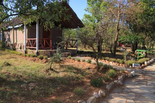 a house with a path in front of it at ELANGATA OLERAI LUXURY TENTED CAMP in Narok