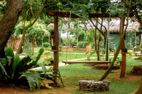 a park with a swing and a tree at Nagara Lake Glamping Resort in Hambantota