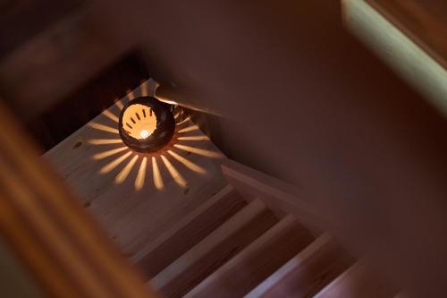 an overhead view of a stairway with a light and a shadow at 博世庵 in Nishikatsuracho