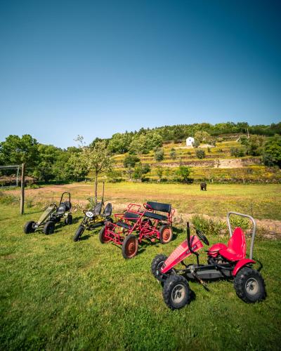 a group of four four wheelers parked in a field at Casa do Marujo e Casa do Mirone in Fornos de Algodres
