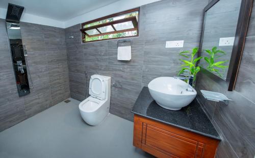 a bathroom with a sink and a toilet in it at VDN House in Kalegana
