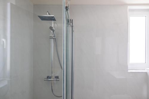 a shower with a glass door in a bathroom at C'est La Vie Boutik Swieqi in Is-Swieqi