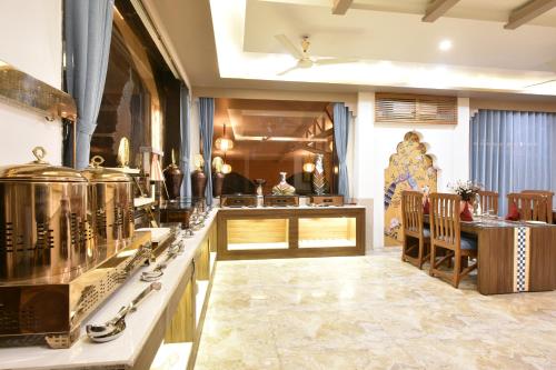 a room with a kitchen with a stove and a counter at Tiaraa Lite A Ganges Retreat in Shivpuri