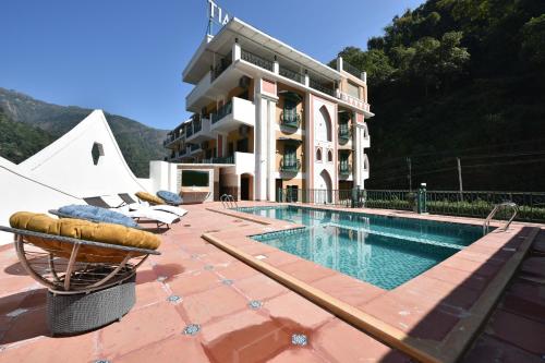 a resort with a swimming pool and a building at Tiaraa Lite A Ganges Retreat in Shivpuri