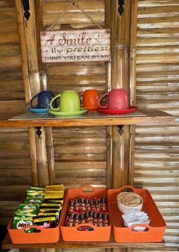 a shelf with different colored bowls and plates on it at Nay Carmen Pension House Port Barton in Itaytay