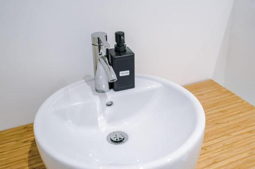 a faucet on top of a white sink at Sleeps 6, Stylish Apartment, Perfect For Groups, Long Term Disc in Otley