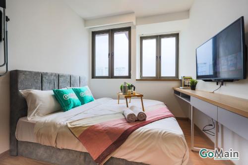 a bedroom with a bed with a desk and a tv at 24h Check in & SkyPool- KL Sentral Suite Riveria City Near KL Sentral KL KLCC in Kuala Lumpur
