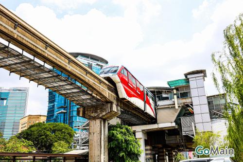 a red and white train on a track at 24h Check in & SkyPool- KL Sentral Suite Riveria City Near KL Sentral KL KLCC in Kuala Lumpur