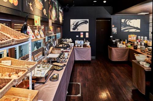 a bakery with a long counter in a store at Hotel Kuu Kyoto in Kyoto