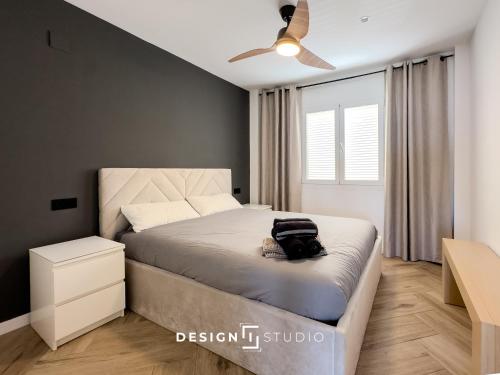 a bedroom with a bed with a backpack on it at Pink Lake view Apartment in Los Altos