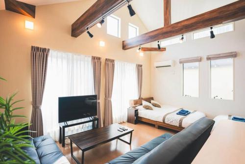 a living room with a couch and a bed at New! U&I Villa close Disney & Narita AP - Great View in Tokyo