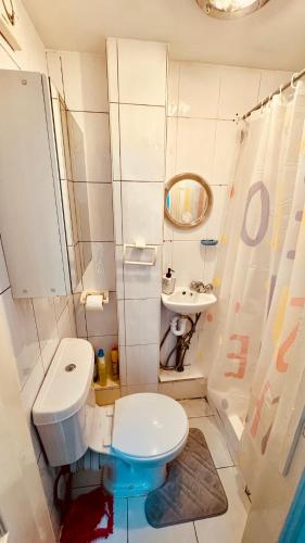 a small bathroom with a toilet and a sink at the quite one in London