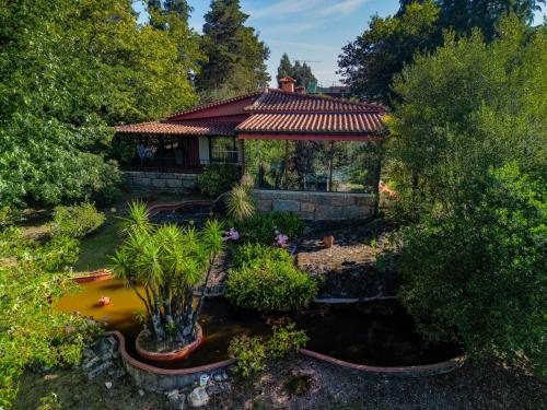 an overhead view of a house with a pond and trees at Quinta de Santa Luzia in Santo Tirso
