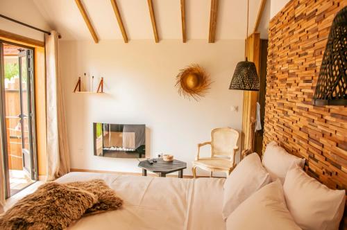 a living room with a white couch and a brick wall at Heritage Ecolodge in Le Tampon