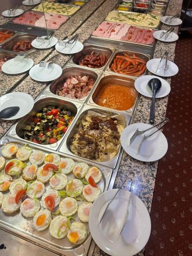 a table with plates of food on top at Hotel Slovakia in Žilina