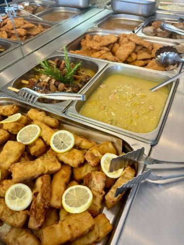 a buffet with a bunch of food with lemon slices at Hotel Slovakia in Žilina