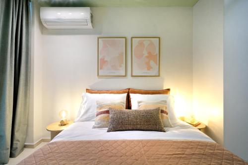 a bedroom with a bed with two pictures on the wall at The Ark Athens in Athens