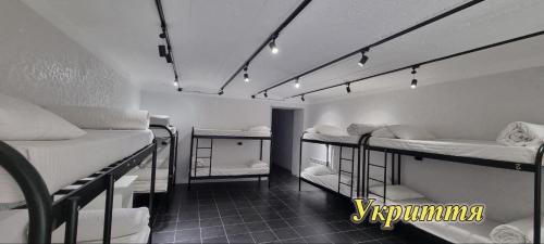 a room with three bunk beds in a room at Kulikovskiy hotel in Kharkiv