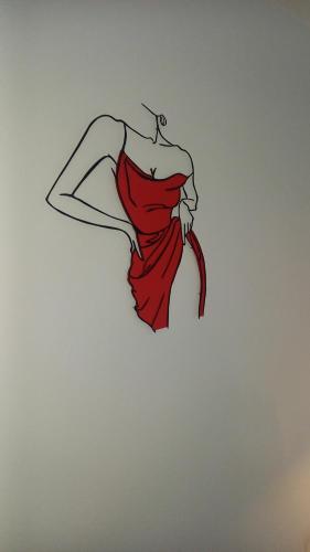 a drawing of a woman in a red dress at Novecento in Bertinoro