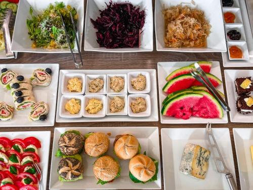 a table topped with white dishes filled with different types of food at U HRÁDKU Superior in Znojmo