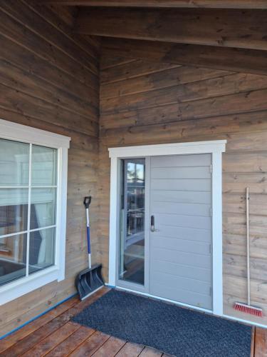 a white garage door on a wooden house at Timmerstugan in Gällivare