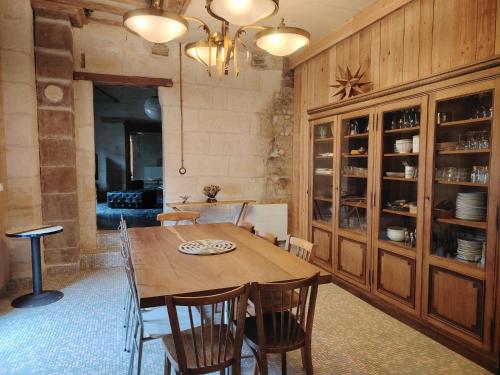 a dining room with a wooden table and chairs at La Belle Étoile in La Chartre-sur-le-Loir
