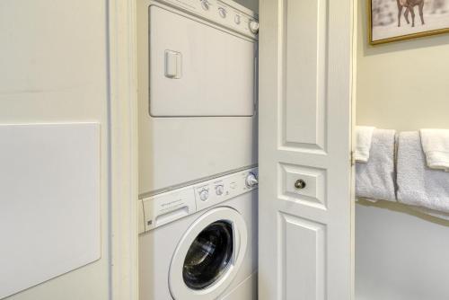 a laundry room with a washer and dryer at Cozy Chalet on the 9th Hole La Bête Pool Golf in Mont-Tremblant