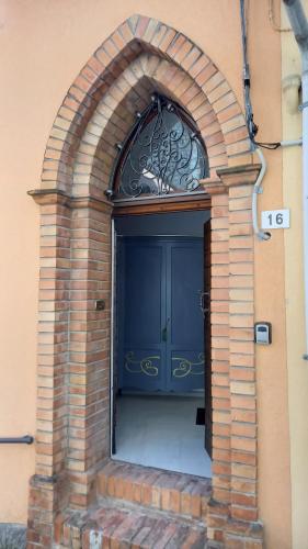 a large blue door in a brick building at Novecento in Bertinoro