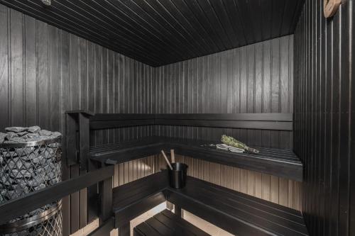 a sauna with a bench in a wooden room at Forenom Aparthotel Jyväskylä in Jyväskylä