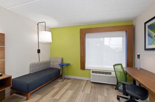 a waiting room with a desk and a chair and a window at Holiday Inn Express & Suites Kings Mountain - Shelby Area by IHG in Kings Mountain