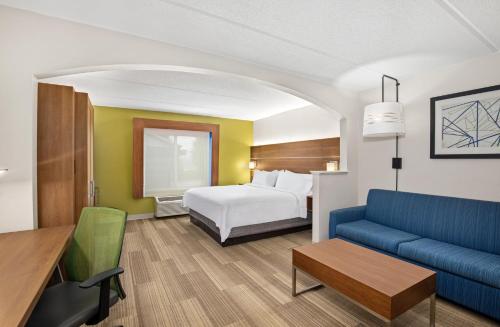 a hotel room with a bed and a couch at Holiday Inn Express & Suites Kings Mountain - Shelby Area by IHG in Kings Mountain