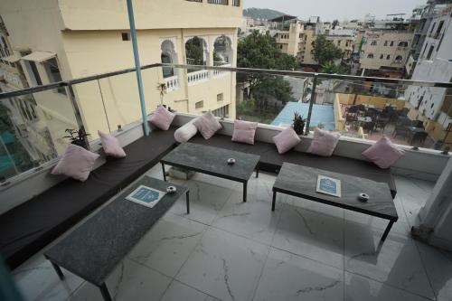 a balcony with a couch and pillows on a building at Hostel Funky Bunky in Udaipur