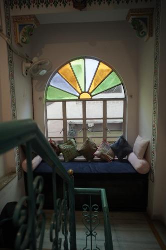 a window with a bunch of pillows in a room at Hostel Funky Bunky in Udaipur