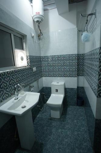 a bathroom with a white sink and a toilet at Hostel Funky Bunky in Udaipur